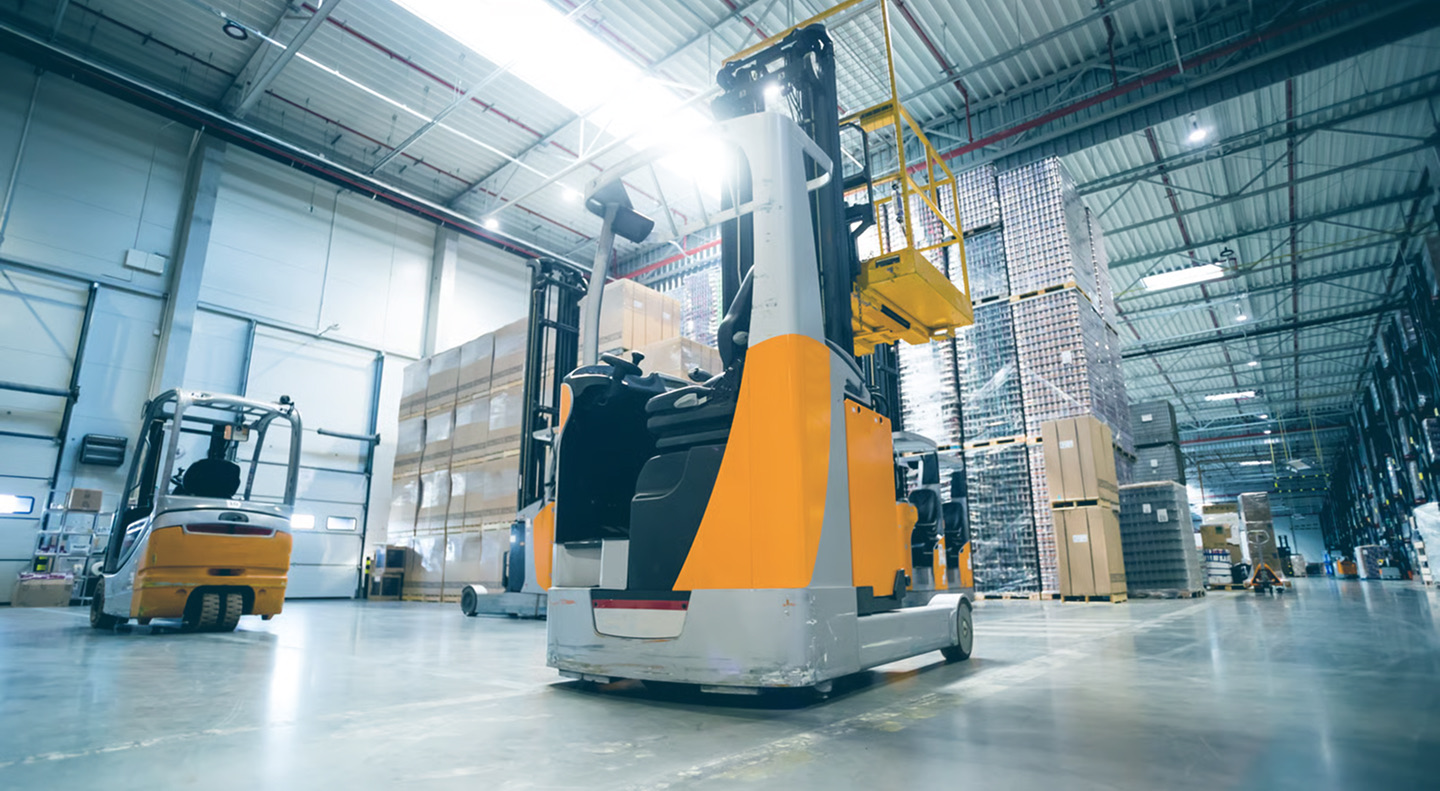 Reach truck operating inside a modern warehouse
