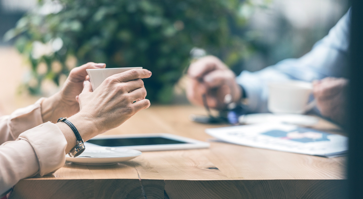 Conversation over coffee at a table