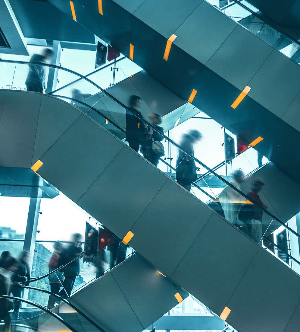People moving through a network of escalators