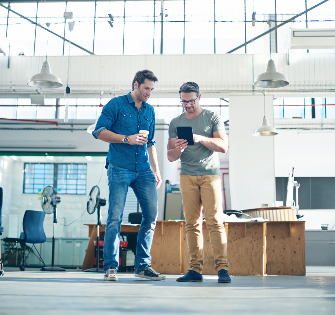 Two people discussing a new venture on a tablet