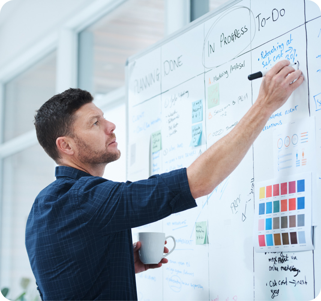 Person planning a strategy on a whiteboard