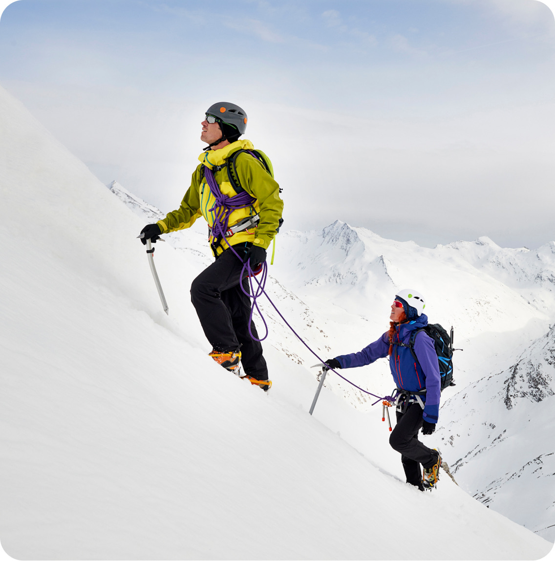 Two mountaineers ascending a snowy slope